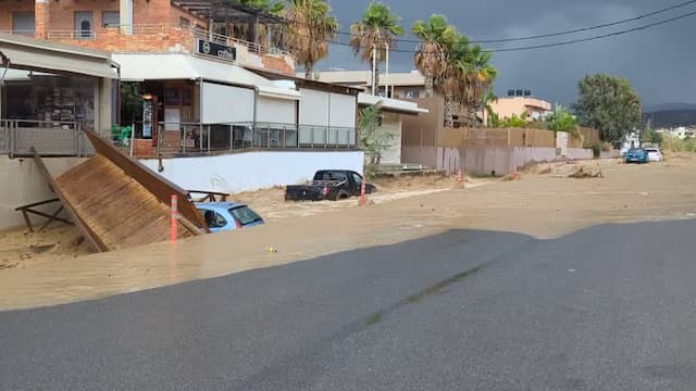 Kolkend water sleurt brug en auto's mee op Kreta