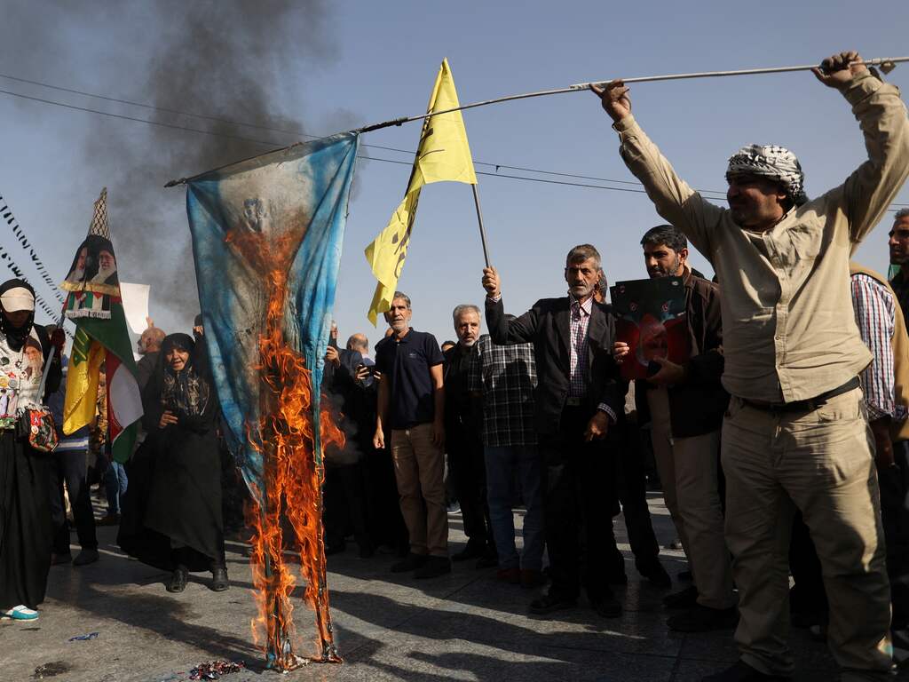 Iranians burn a painted Israeli flag during a gathering to support the IRGC attack on Israel, in Tehran, Iran, October 2, 2024.