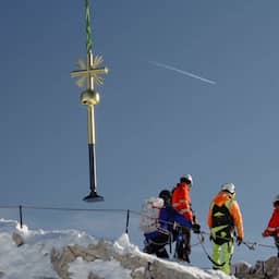 Video | Helikopter plaatst topkruis terug op hoogste berg van Duitsland